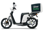 A White Electric Scooter With A Large Uber Eats Delivery Box Mounted On The Back, Perfect For Those Looking To Rent A Scooter In London, Shown From The Side Against A White Background.